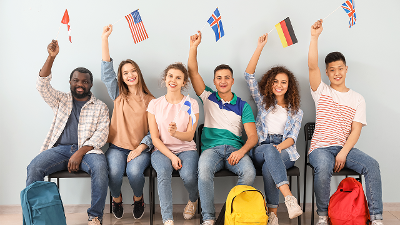 Diverse group of students waving flags from various countries