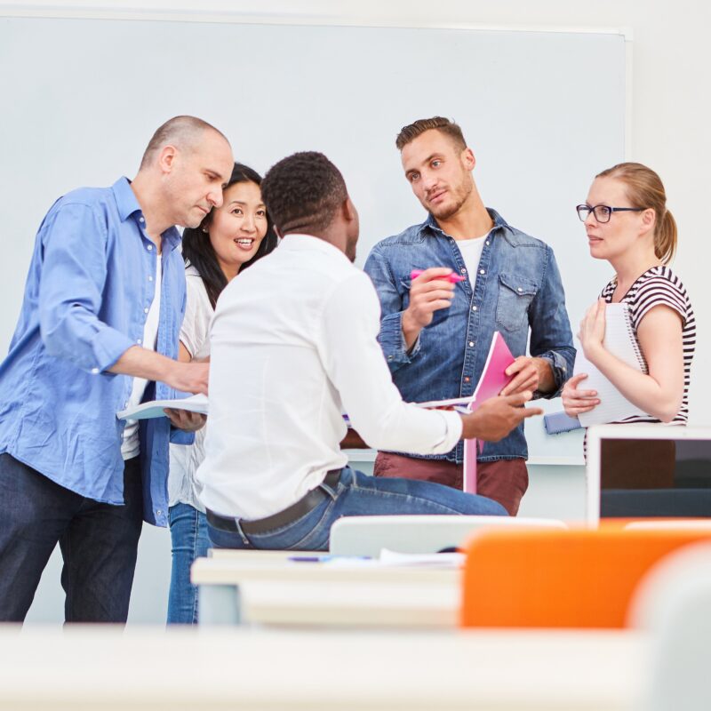 Group of five people passionately talking in an office