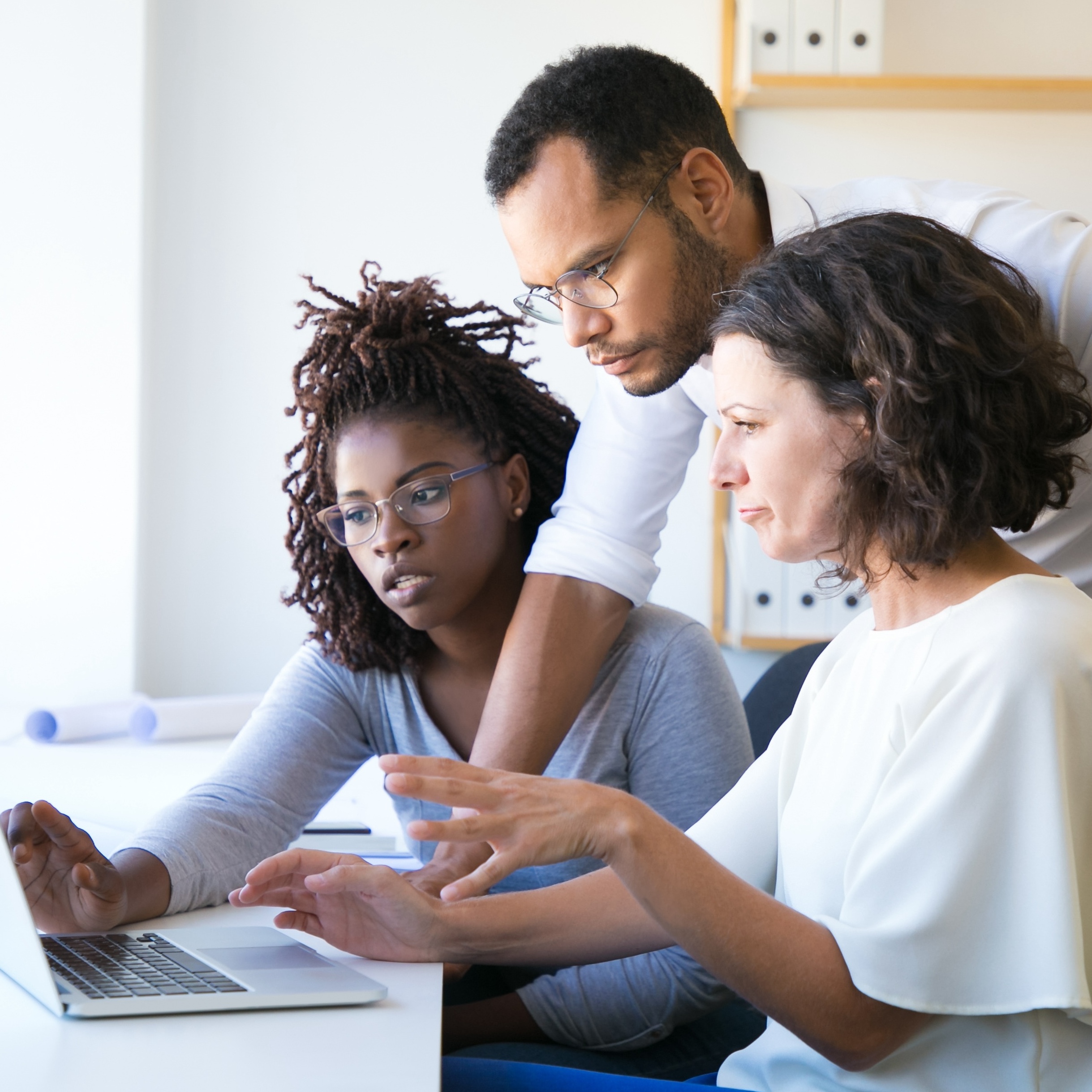 Instructor helping new employees with corporate software