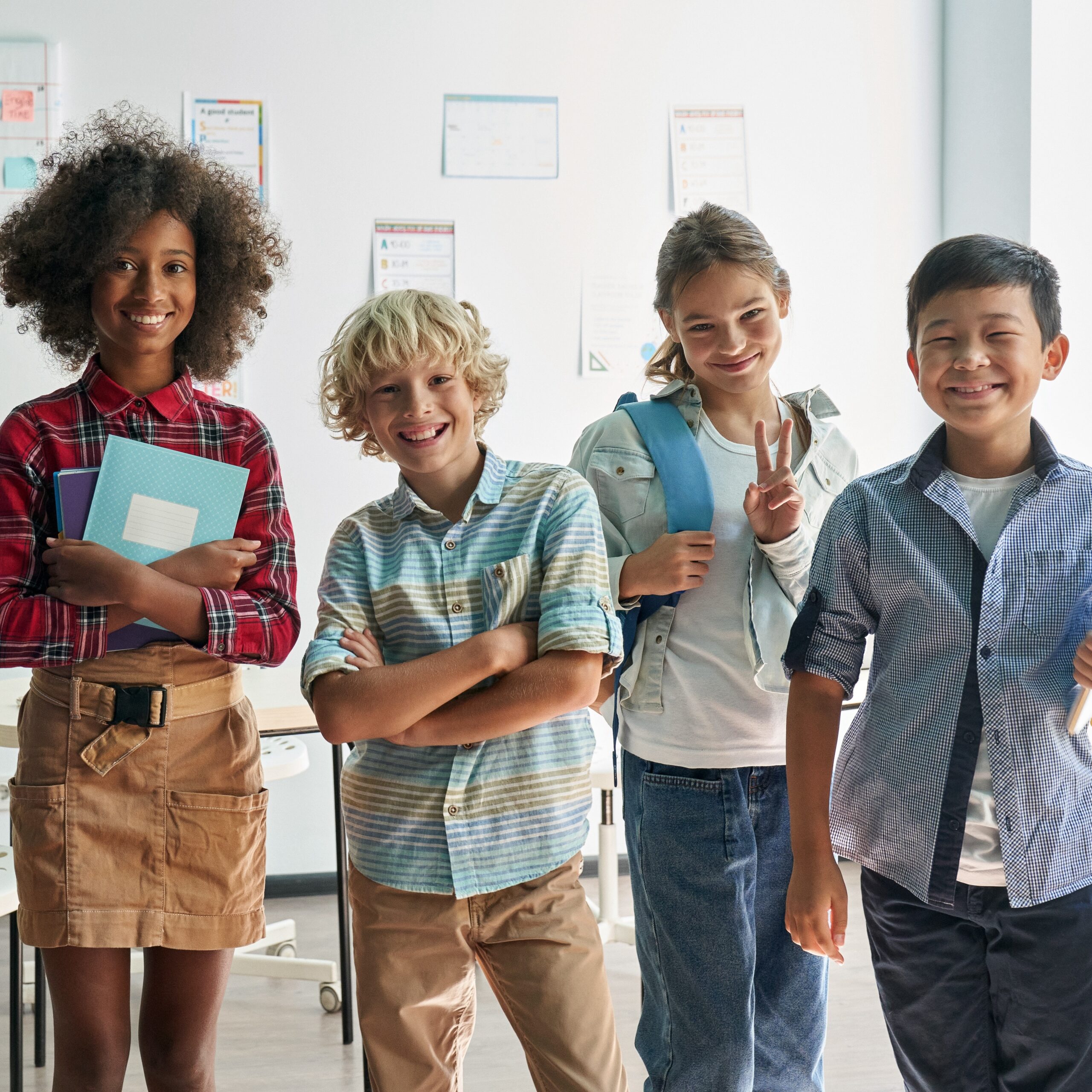 Portrait of happy cheerful smiling diverse schoolchildren in classroom.