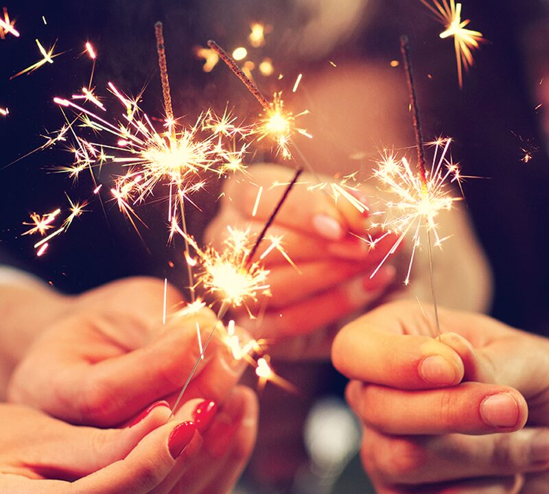 People holding sparklers in celebration