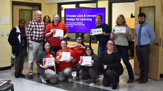 A group of adults from the Choose Love project smiling at the camera, Two groups of adult learners posing by making heart shapes with their hands